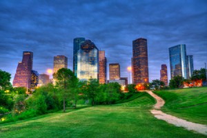 Houston Texas modern skyline at sunset twilight from park lawn